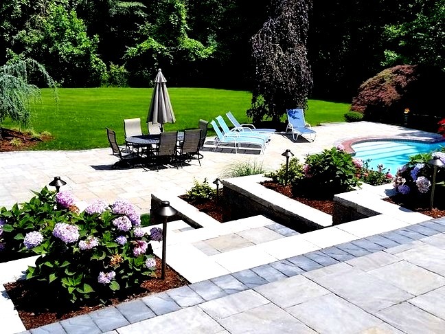 Pool - large traditional backyard stone and custom-shaped lap pool idea